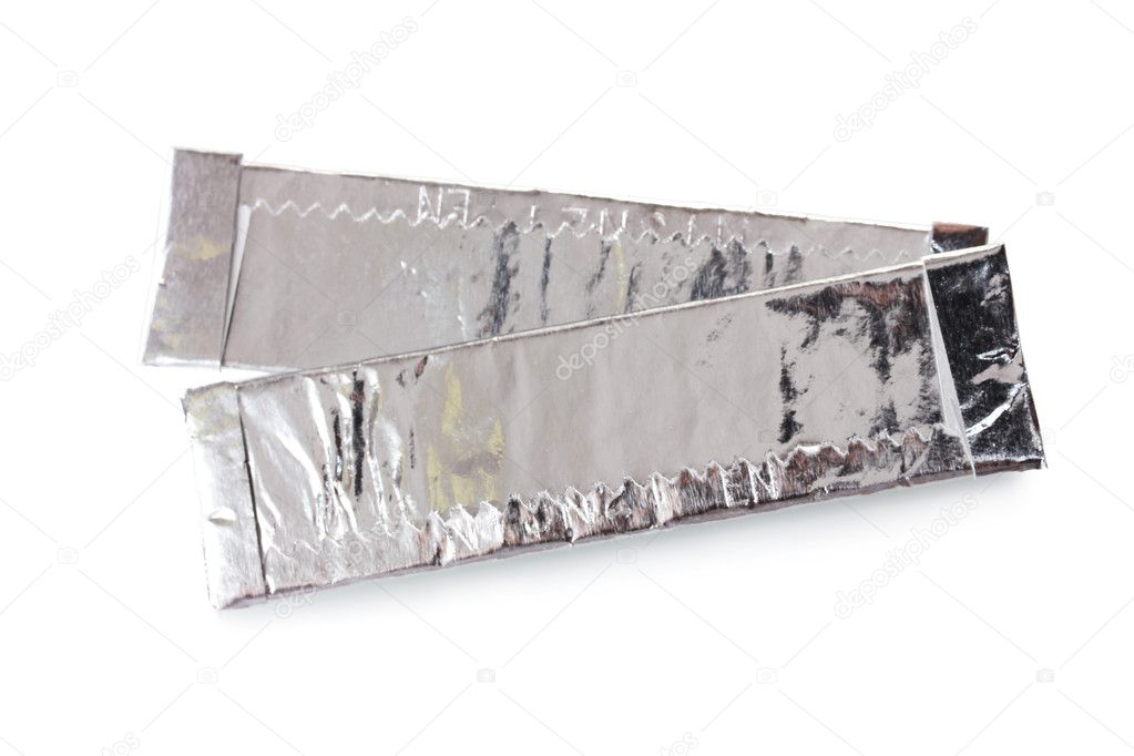Two chewing gums wrapped in standard silver foil, isolated on white