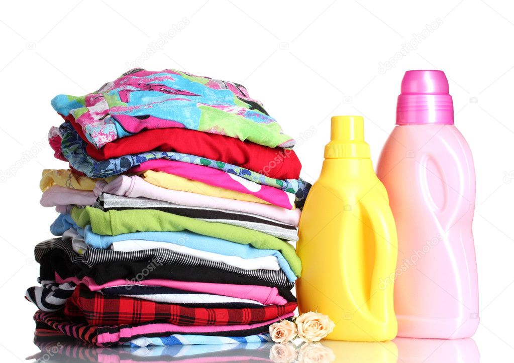 Detergent and pile of colorful clothes isolated on white