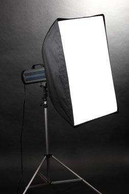 Studio flash with soft-box on grey background clipart