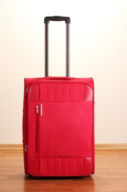 Red suitcase isolated in the room clipart