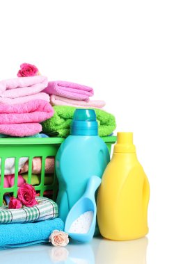 Detergents and towels in green plastic basket isolated on white clipart