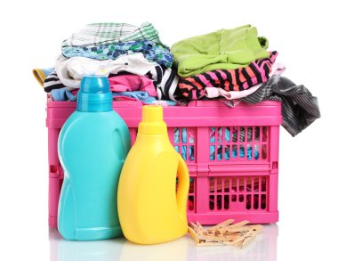 Clothes with detergent in pink plastic basket isolated on white clipart