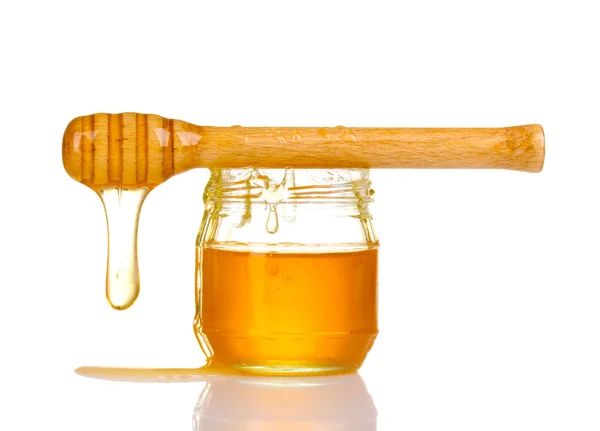Jar of honey and wooden drizzler isolated on white — Stock Photo, Image