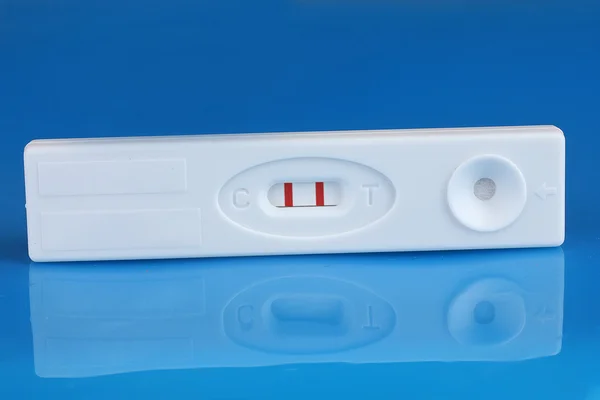 stock image Positive pregnancy test on blue background