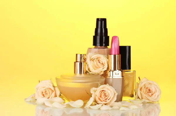 Сosmetics with roses on yellow — Stock Photo, Image