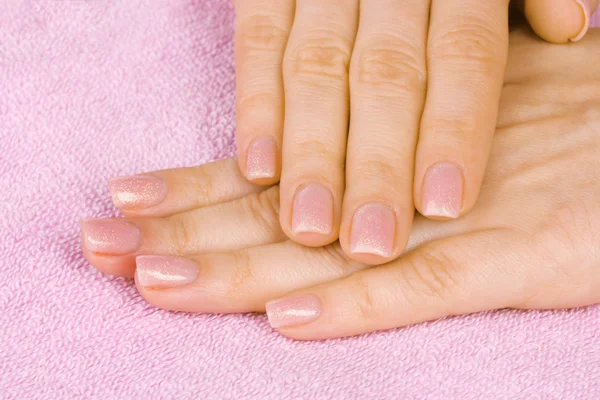 Toalha rosa e mãos closeup — Fotografia de Stock