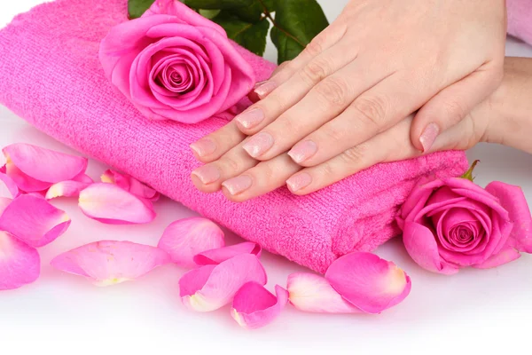 Toalla rosa con rosas y manos sobre fondo blanco — Foto de Stock