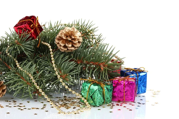 Green Christmas tree with gift and cones isolated on white — Stock Photo, Image