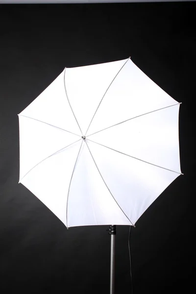 stock image Studio flash with umbrella on grey background