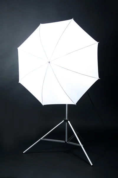 Студійний спалах з парасолькою на сірому фоні — стокове фото
