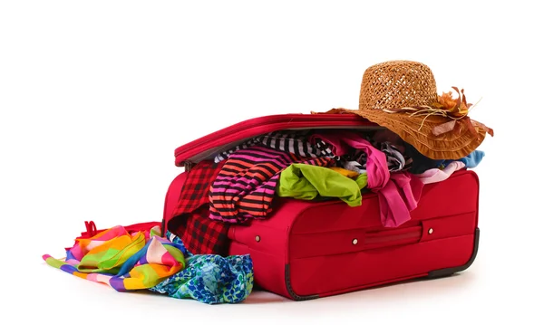 ? losed röda resväska med kläder isolerad på en vit — Stockfoto
