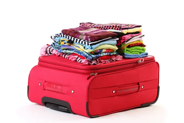 Valise rouge zippée avec vêtements isolés sur blanc — Photo