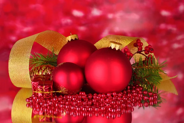 Christmas ball and green tree on red — Stock Photo, Image