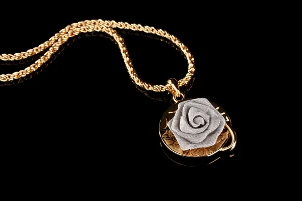 Pendant in form of rose on black — Stock Photo, Image