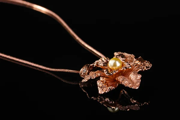 Pendant in form of flower with pearl isolated on black — Stock Photo, Image