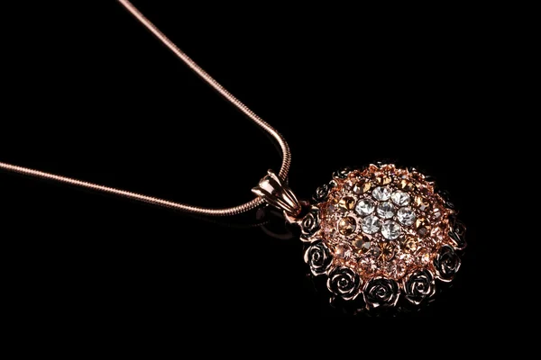 Pendant with flowers and gems isolated on black — Stock Photo, Image