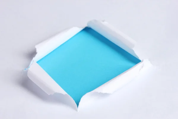 撕的纸与蓝色背景 — 图库照片