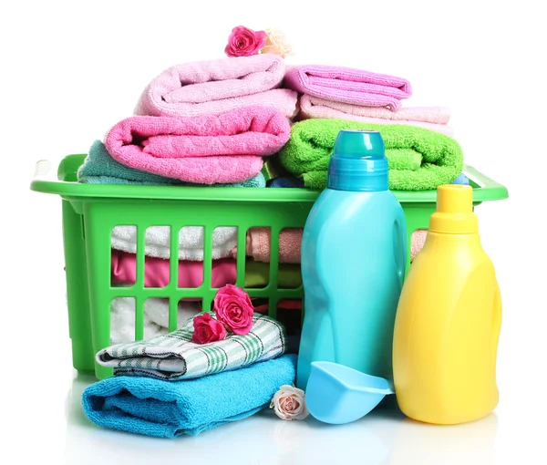 Detergents and towels in green plastic basket isolated on white — Stock Photo, Image