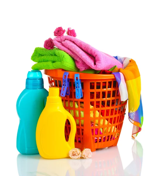 Clothes with detergent in orange plastic basket isolated on white — Stock Photo, Image