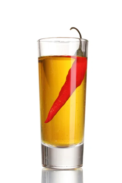 stock image Glass of pepper vodka and red chili pepper isolated on white