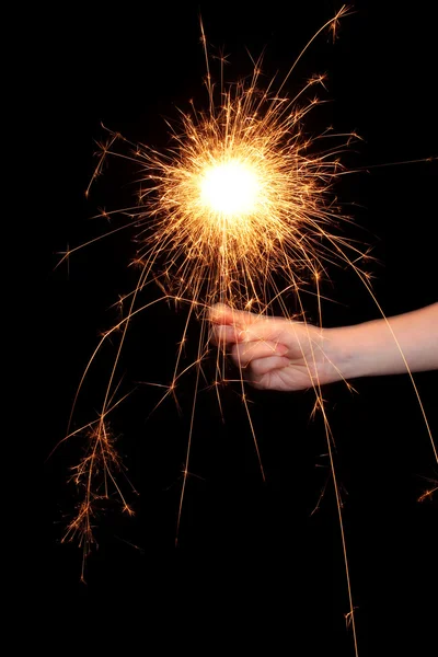 Beautiful sparkler in hand on black background — Stock Photo, Image