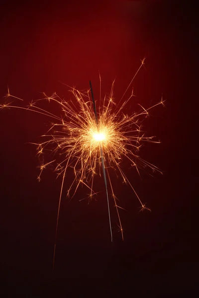 Beautiful sparkler on red background — Stock Photo, Image