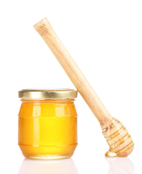 Jar of honey and wooden drizzler isolated on white Royalty Free Stock Images