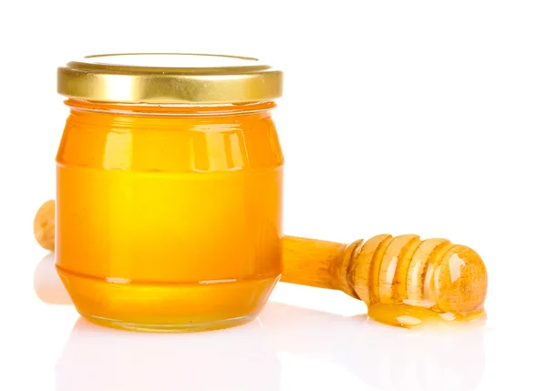 Jar of honey and wooden drizzler isolated on white Royalty Free Stock Images