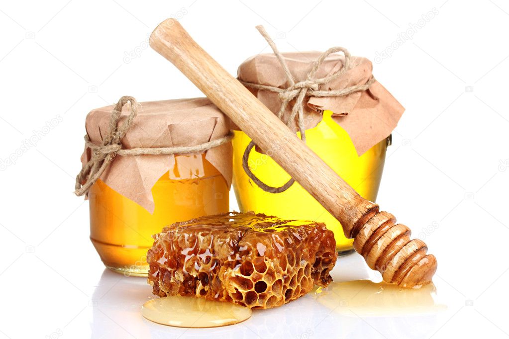 Two jars of honey, honeycombs and wooden drizzler isolated on white