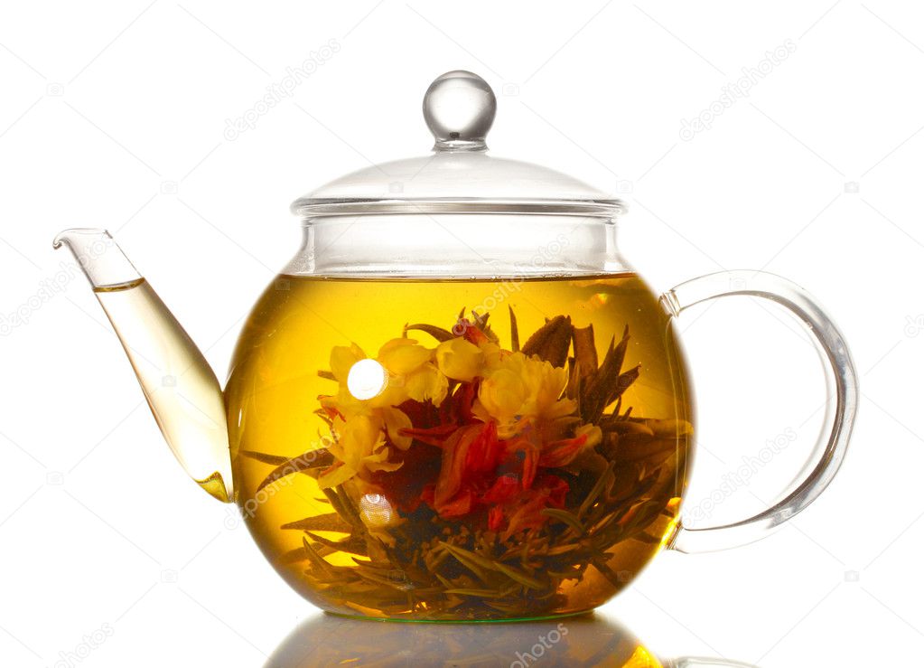 Exotic green tea with flowers in glass teapot isolated on white