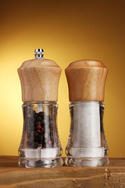 stock image Salt and pepper mills on yellow