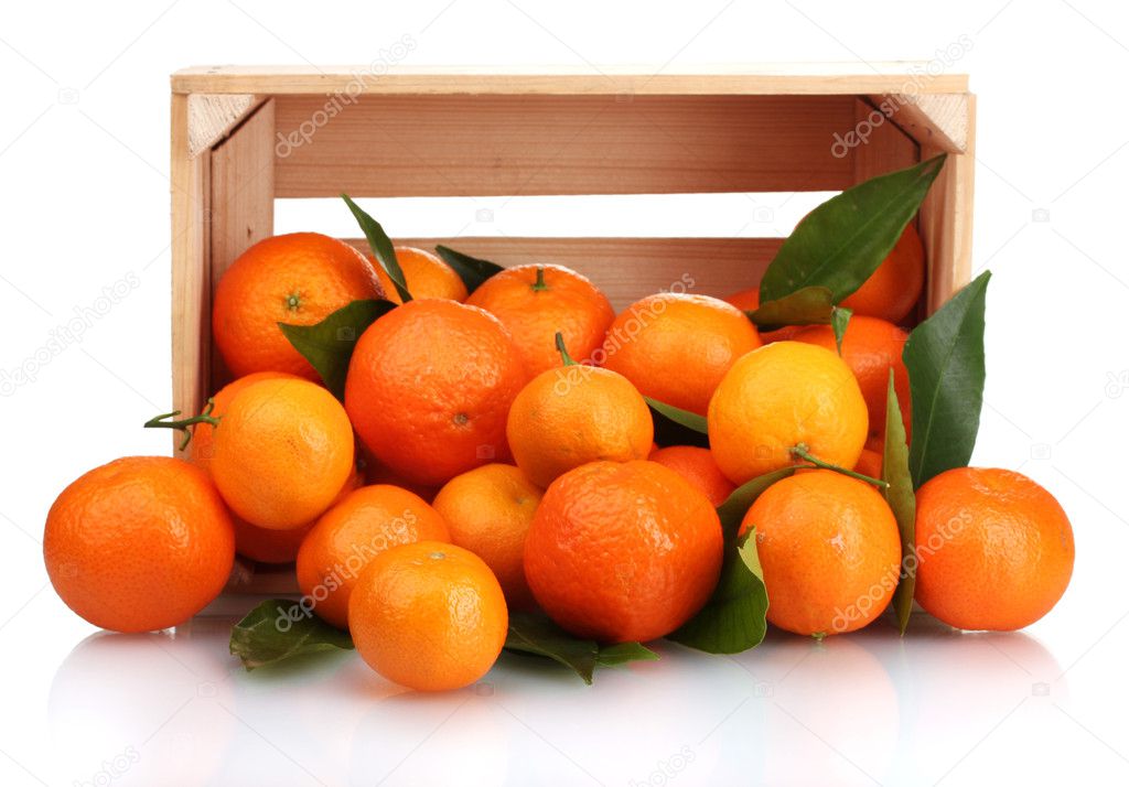 Ripe tasty tangerines with leaves in wooden box dropped isolated on white