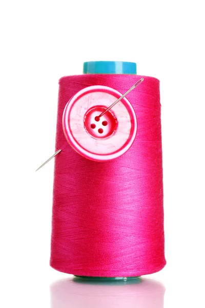 Pink bobbin thread with needle and pink button isolated on white — Stock Photo, Image