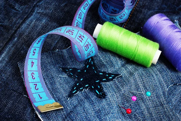 Parche en forma de estrella en jeans con hilos y botones de primer plano —  Fotos de Stock