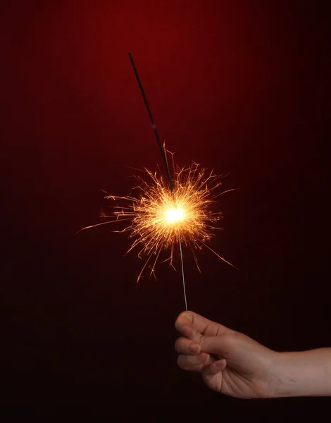 Beautiful sparkler on red background — Stock Photo, Image