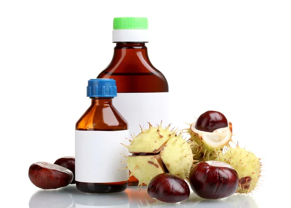 Green and brown chestnuts and medical bottles isolated on white — Stock Photo, Image