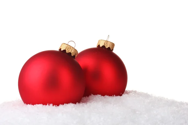 Beautiful red Christmas ball in snow isolated on white — Stock Photo, Image