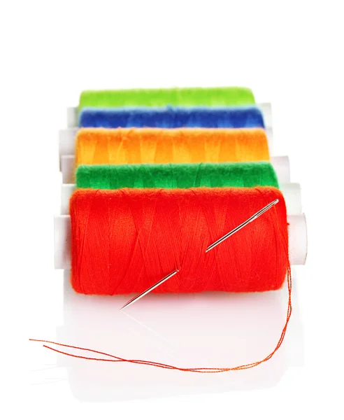 Bobbins of thread with needle isolated on white — Stock Photo, Image