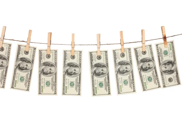 Alot of one hundred dollar bills is hanging on a rope with wooden clothespi — Stock Photo, Image