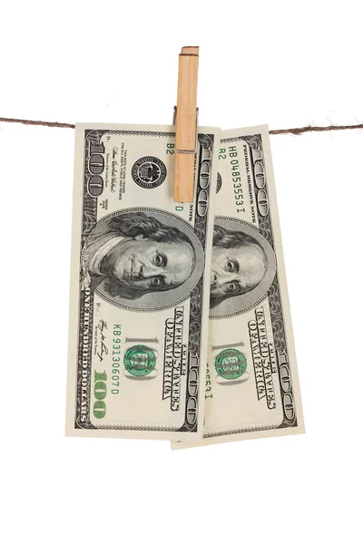 Two one hundred dollar bills is hanging on a rope with wooden clothespin is — Stock Photo, Image