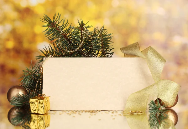 Blank postcard, Christmas balls and fir-tree on yellow background Royalty Free Stock Images