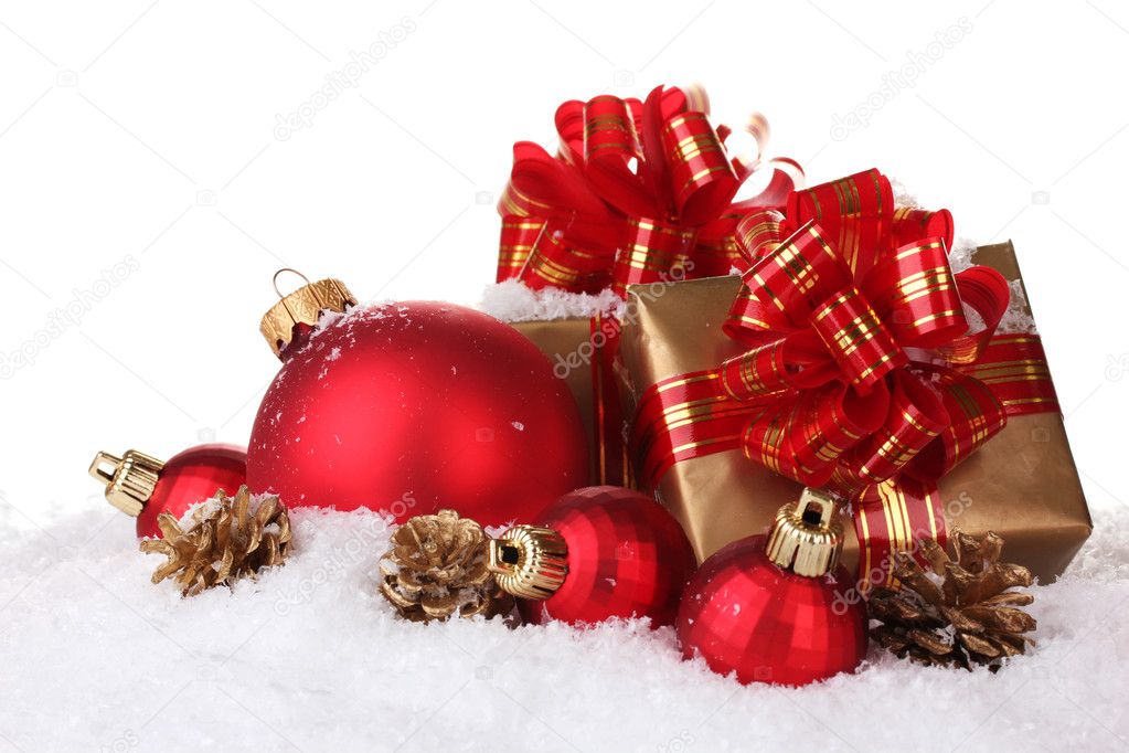 Beautiful red Christmas balls, gifts and cones on snow isolated on white