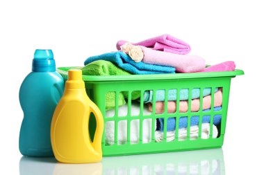 Detergents and towels in green plastic basket isolated on white clipart