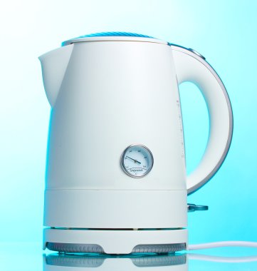 White electric kettle on blue clipart