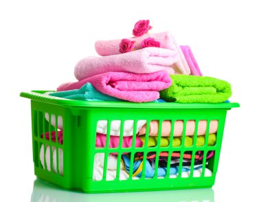 Towels in green plastic basket isolated on white clipart