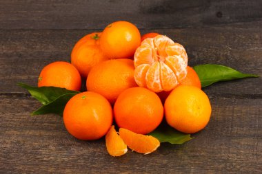 Tangerines with leaves on wooden grey table