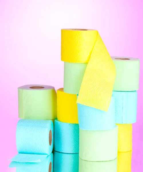Bright rolls of toilet paper on pink background — Zdjęcie stockowe