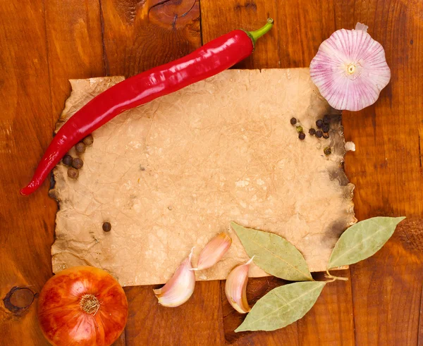 Stock image Old paper for recipes and spices on wooden table