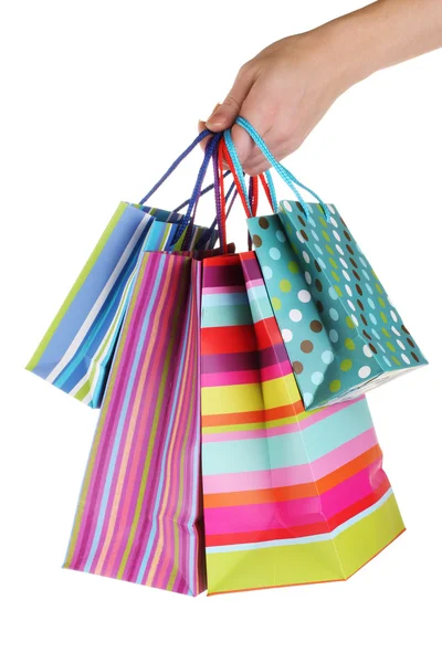Bright gift bags in hand isolated on white — Stock Photo, Image