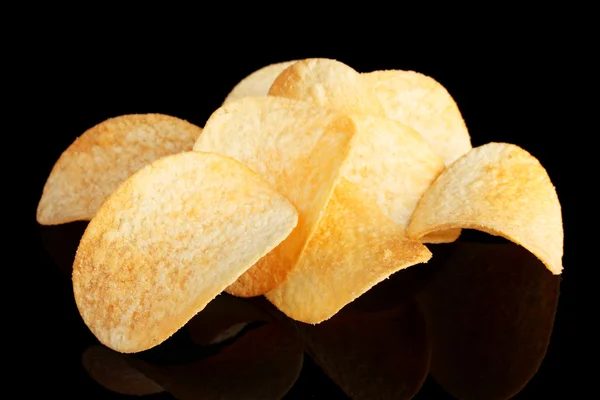 stock image Delicious potato chips on black background